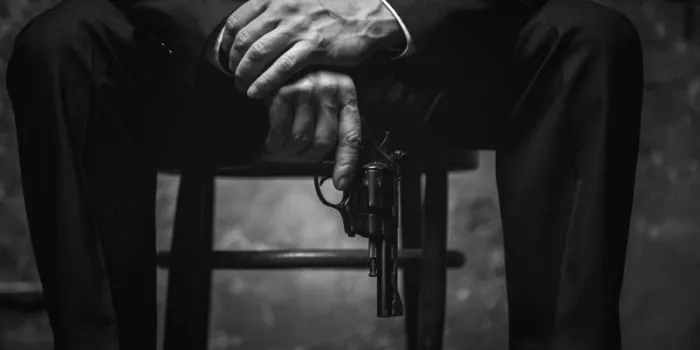 better not irritate me dangerous aggressive mighty man sitting on a chair wearing stylish suit and blackmailing his business rival