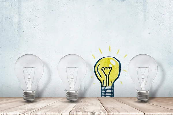 Three lightbulbs, one glowing