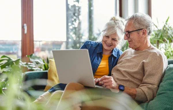 An older couple using a laptop
