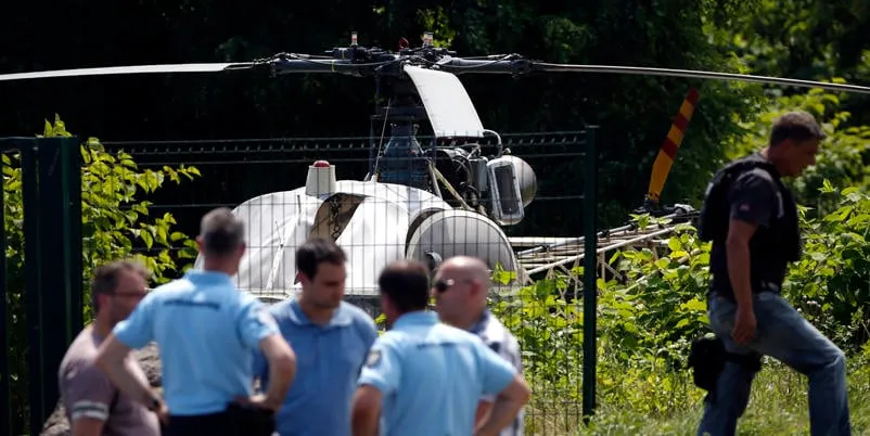 this picture taken on july 1, 2018 in gonesse, north of paris shows police near a french helicopter alouette ii abandoned by french armed robber redoine faid after his escape from prison in reau   afp photo   geoffroy van der hasselt