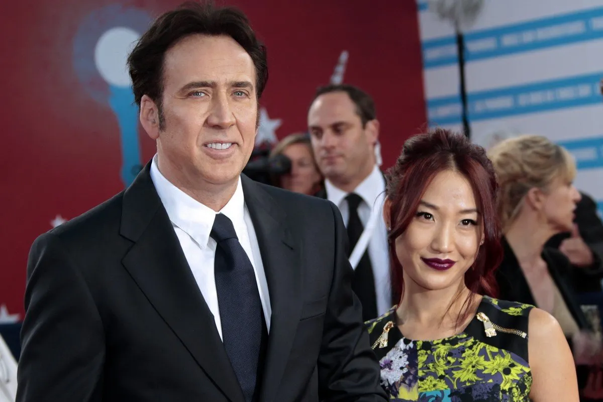 us actor nicolas cage and alice kim pose before the screening of joe at the 39th deauville american film festival on september 2, 2013 in the french northwestern sea resort of deauville afp photo charly triballeau (photo by charly triballeau   afp)