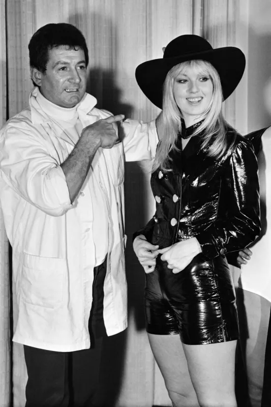 french actress mylene demongeot (r) presents a creation of french designer jean barthet (l) during spring-summer collection on january 23, 1971 in paris (photo by -   afp)