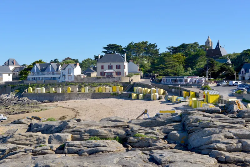 beach of saint michel with its yellow beach huts of batz-sur-mer, a commune in the loire-atlantique department in western france the town lies between the bay of biscay and its salt marshes