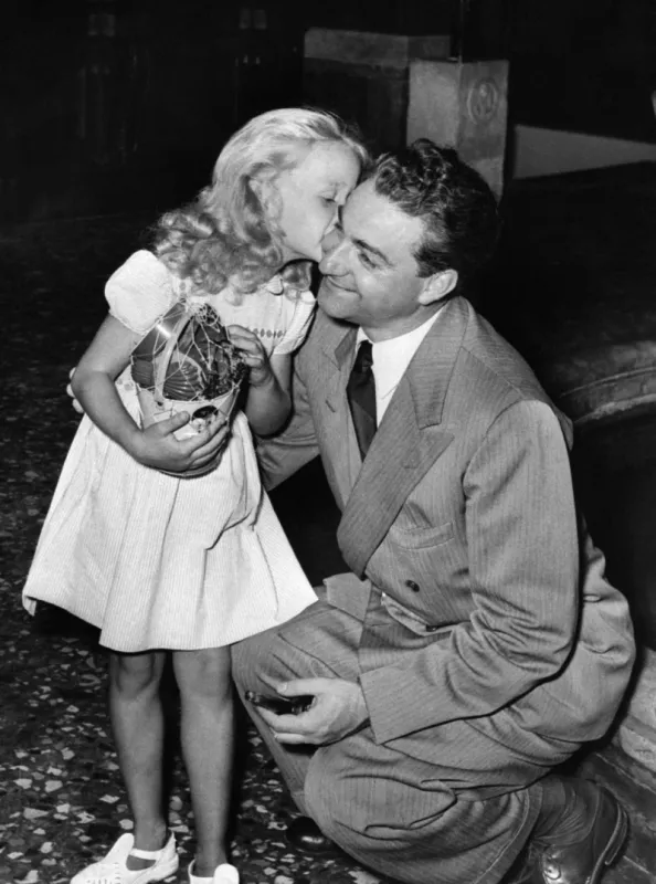 five-year old french actress brigitte fossey, who plays paulette in forbidden games (jeux interdits) kisses french director rené clément in 1952 (photo by -   afp)