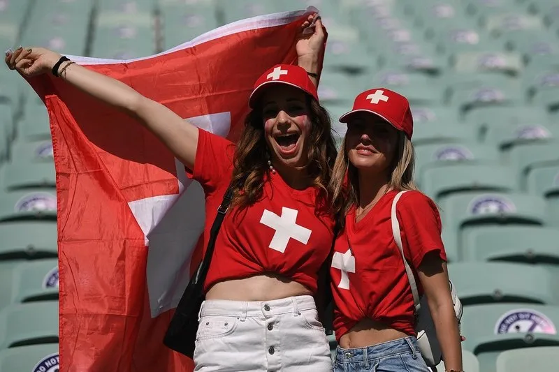 switzerland supporters wage the national flag ahead of the uefa euro 2020 group a football match between wales and switzerland at the olympic stadium in baku on june 12, 2021 (photo by ozan kose   pool   afp)