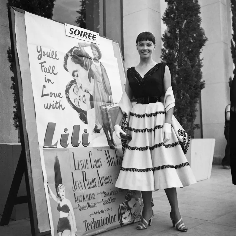 franco-american actress and dancer leslie caron poses in may 1953 in front of the poster for lili, selected at that year's cannes film festival (photo by -   afp)