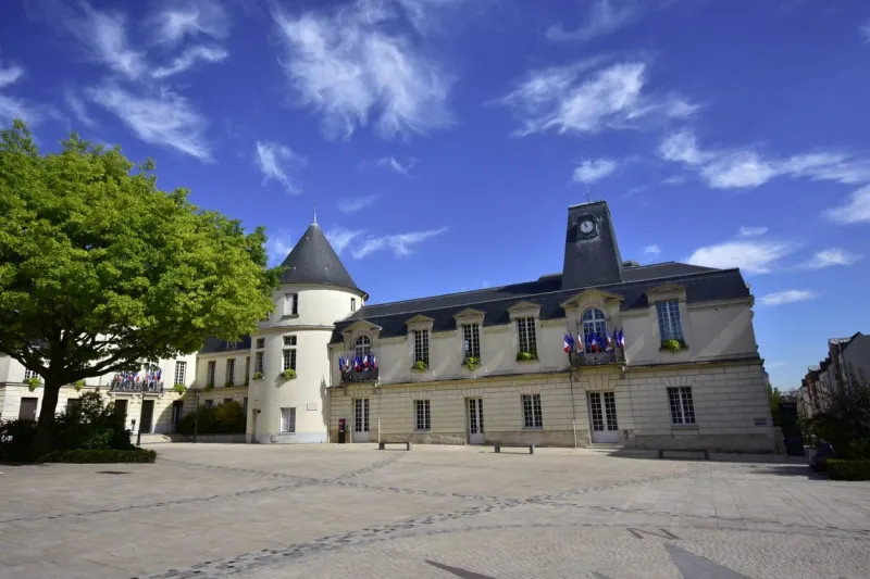 town hall of clamart, france, with french and european flags, beautiful blue sky, august