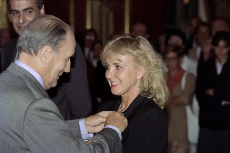 french president francois mitterrand (l) awards french actress bulle ogier with the legion d'honneur during a ceremony at the elysee palace in paris on september 19, 1990 (photo by pascal george   afp)