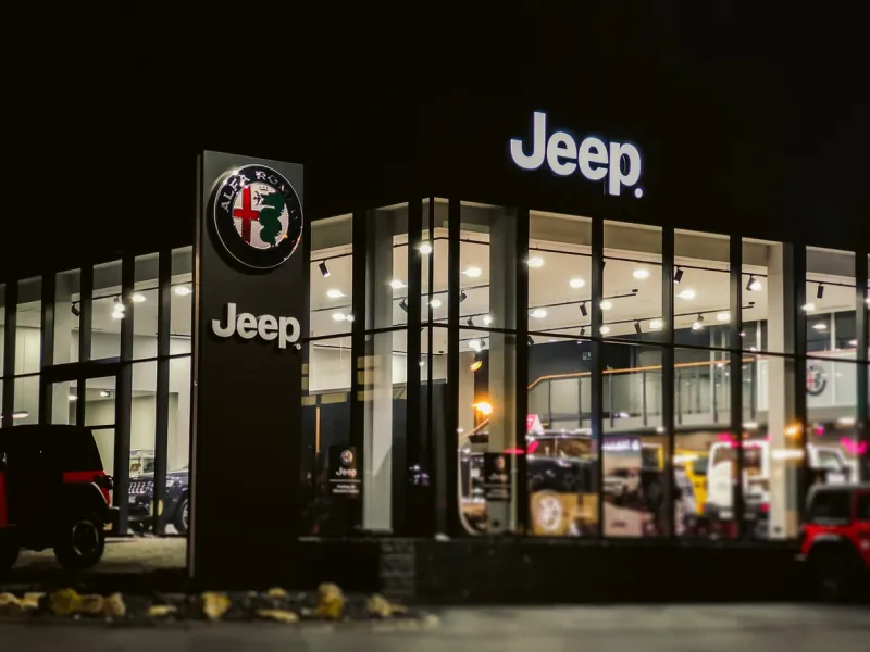 04 03 2019 kraków, małopolskie poland  building with exhibition of jeep alfa romeo car dealer - night view