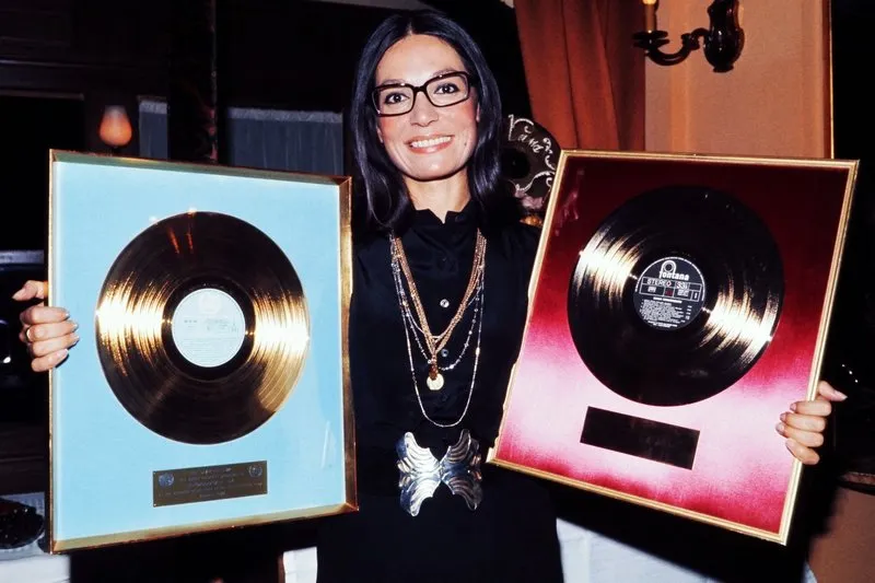 greek singer nana mouskouri poses in september 1973 with her two gold discs for record sales (photo by -   afp)