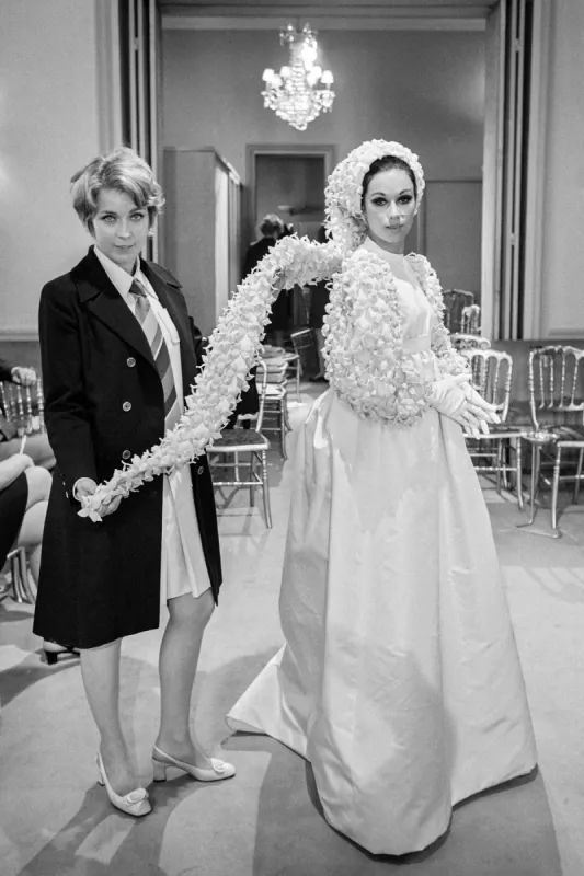 french singer marie dubois admires the wedding dress created by guy laroche after attending the autumn-winter 1968 1969 collection show, on july 26, 1968 in paris (photo by -   afp)