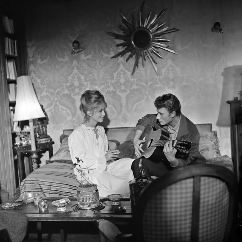 singer johnny hallyday rehearses a scene on the set of the film les parisiennes with actress catherine deneuve (g) during the year 1961 (photo by upi   afp)