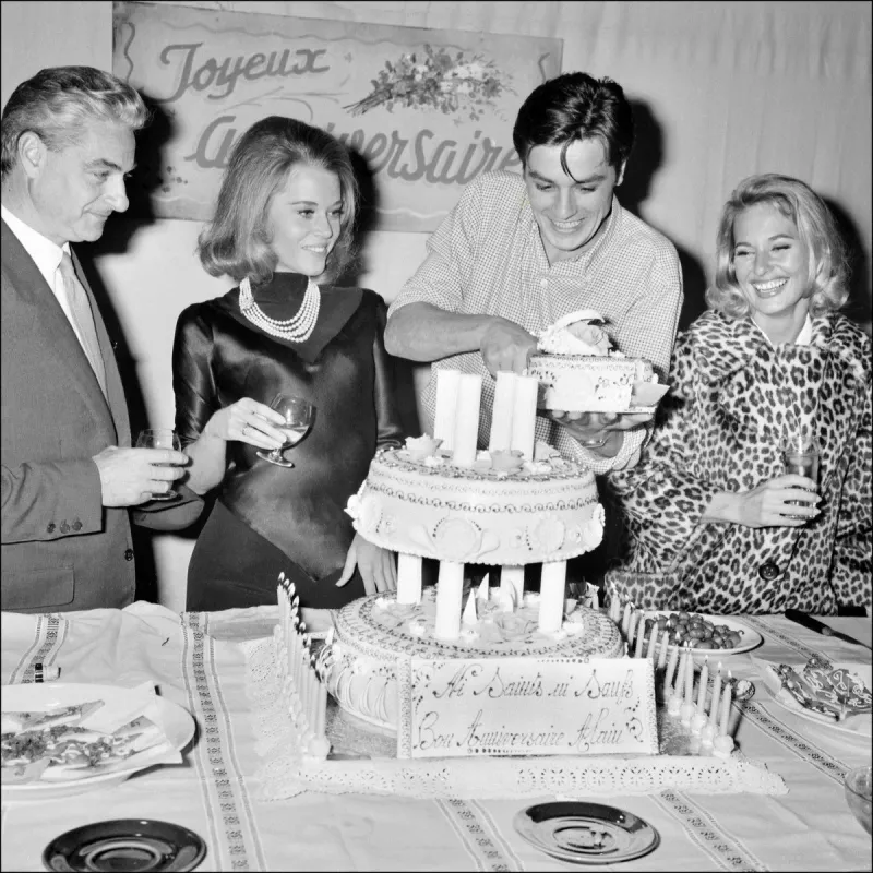 french director rené clément (l), us actress jane fonda and an unidentified pwoman celebrate the 28th birthday of french actor alain delon (2nd r) on november 8, 1963 (photo by upi   afp)