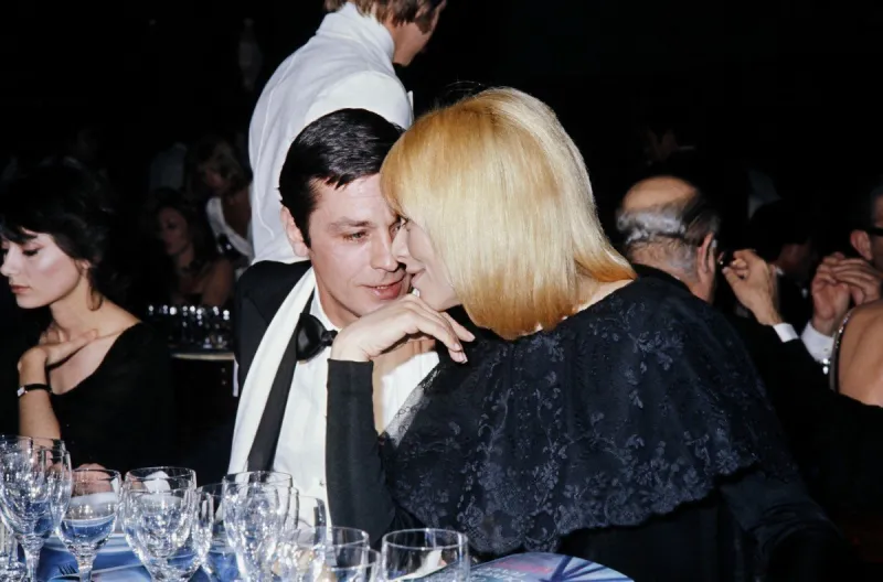 photo taken in january 1976 shows french actor alain delon and his companion, actress mireille darc, during a gala event at the casino ruhl in nice, southern france (photo by afp)