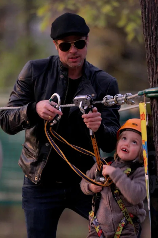 brad pitt and angelina jolie take their children to a park - budapest