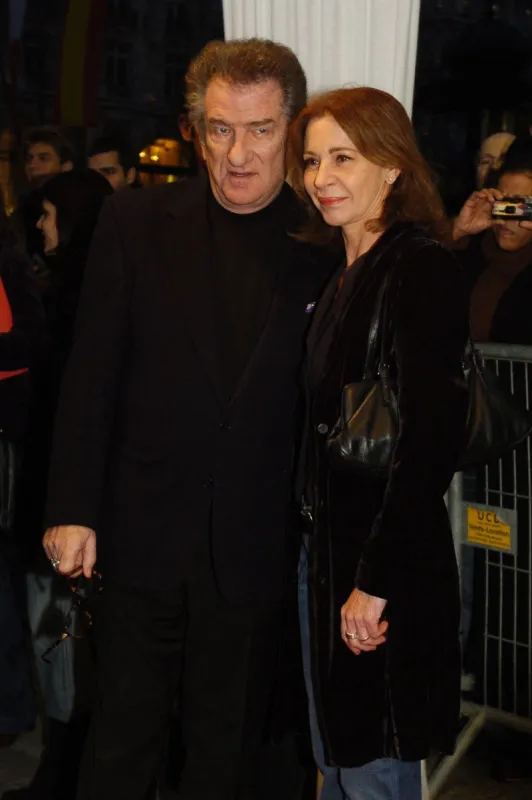 french singer and actor eddy mitchell arrives with his wife for the screening of french director laurent tuel's film jean-philippe, 28 march 2006 in paris  afp photo jean ayissi (photo by jean ayissi   afp)