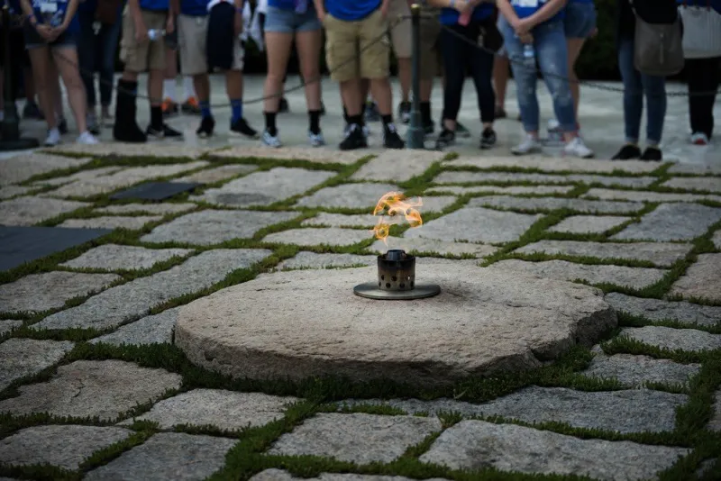 people visit the eternal flame at the grave of assassinated former us president john f kennedy near the 100th anniversary of his birth at arlington national cemetery may 26, 2017 in arlington, virginia (photo by brendan smialowski   afp)