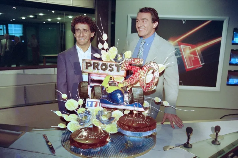 french journalist jean-pierre pernaut (r) and french formula one driver alain prost celebrate the 50th grand prix award for the french champion after the tv news broadcast by french tv station tf1 in paris on july 12, 1993 (photo by pierre boussel   afp)