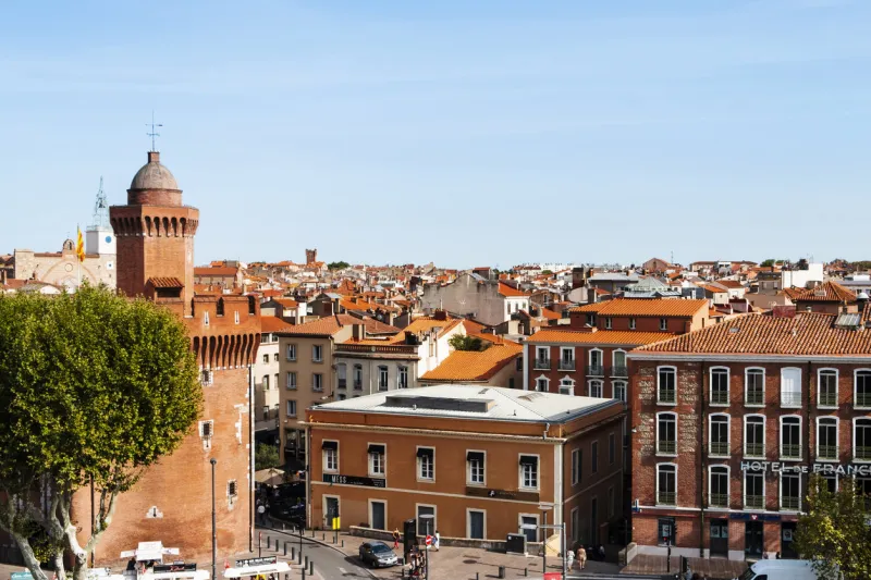 perpignan, france - september 14, 2019  aerial view of the old town of perpignan, france, highlighting on the left le castillet bastion, an iconic landmark in the city, built on the fourteenth century