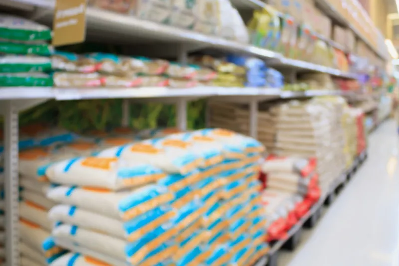 rice shelves in supermarket store blurred background