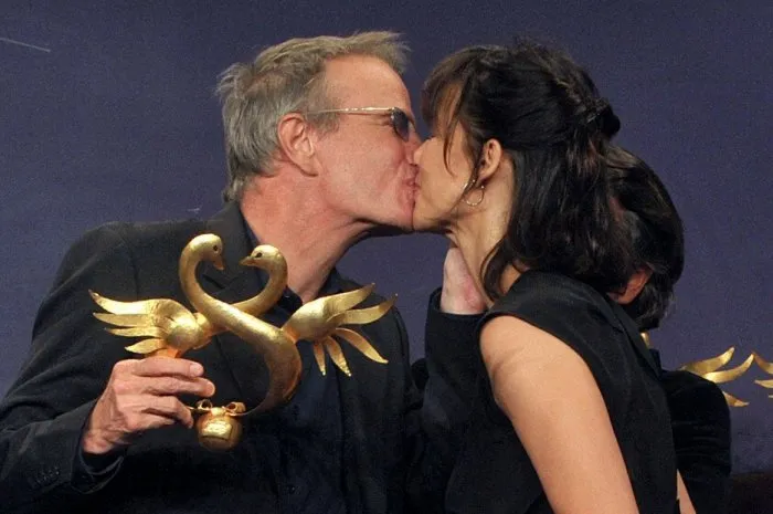 christophe lambert receives a 'gold swan' for his lifetime achievement from his companion sophie marceau during the closing ceremony of the 24th cabourg romantic film festival in cabourg, france on june 12, 2010 photo by giancarlo gorassini abacapresscom