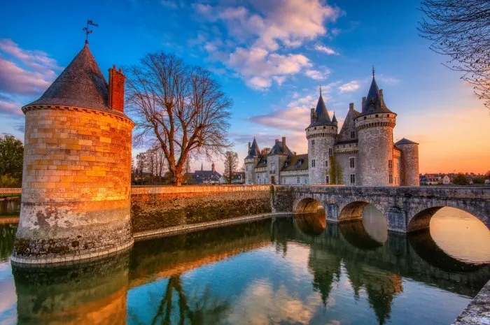 sully sur loire, france - april 13, 2019  famous medieval castle sully sur loire at sunset, loire valley, france the chateau of sully sur loire dates from the end of the 14th century and is a prime example of medieval fortress blue hour