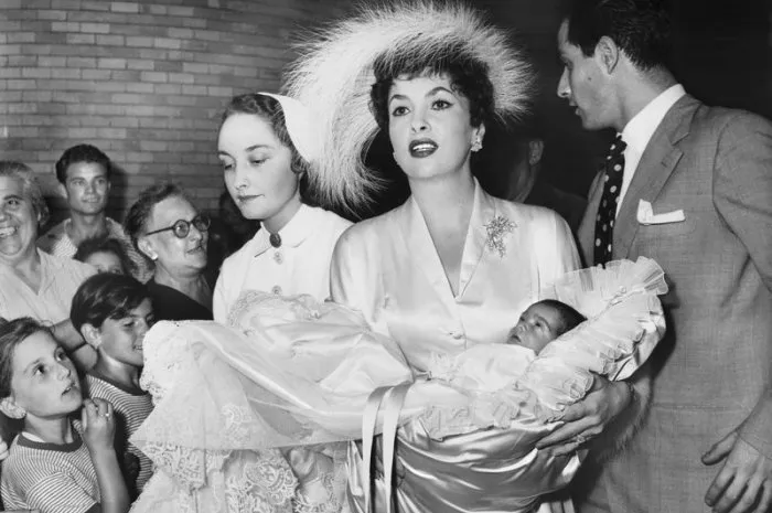 gina lollobrigida holds her son milko during his baptism in italy, 1950 her husband milko skofic stands on her side photo by dpa abacapresscom , 256809 003 - italie italy