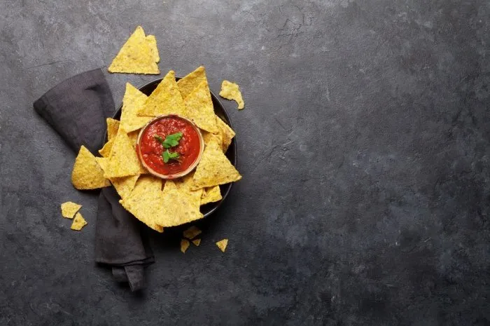 mexican nachos chips with salsa sauce top view flat lay on stone table with copy space