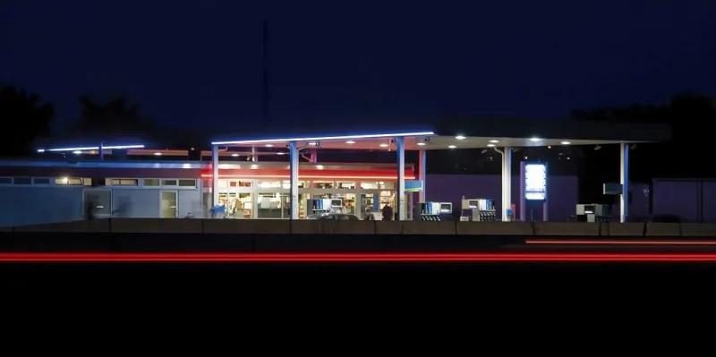 illuminated service station near highway in germany at late evening time