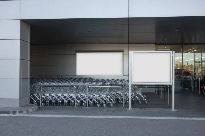 blank billboard in a supermarket, next to shopping carts