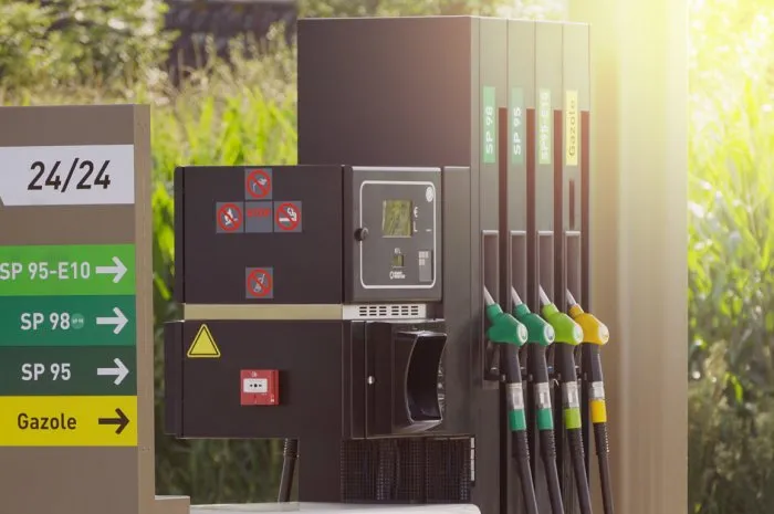 fuel pumps at a gas station, informations signs fuel nozzle in oil dispenser petrol gun filling green and golden colors