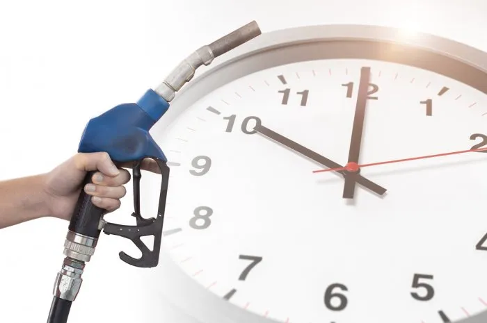 fuel nozzle overlay with time clock for fossil oil gasoline run out countdown timing concept