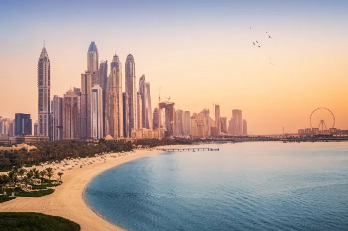 sunset view of the dubai marina and jbr area and the famous ferris wheel and golden sand beaches in the persian gulf holidays and vacations in the uae