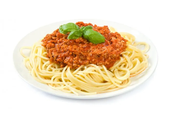 a whole plate of spaghetti bolognese isolated on white