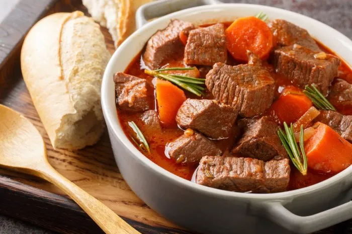 french beef stew in red wine known as daube de boeuf provencal closeup in the wooden tray on the table horizontal