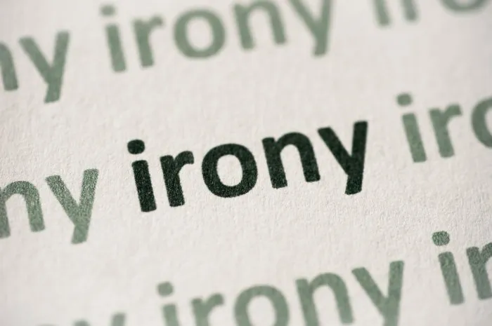 word irony printed on white paper macro