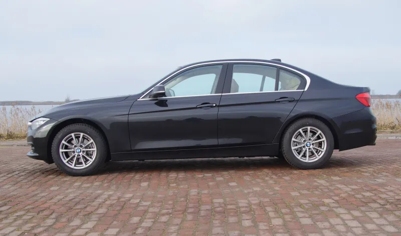 almere, flevoland, the netherlands - februari 5, 2017  black bmw 320i parked by the side of the road in the city of almere nobody in the vehicle