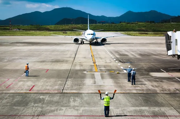 view from ishigaki airport observatory when the plane lands, marshaller guides the aircraft to the parking apron  ishigaki airport, okinawa prefecture  10-26-2018
