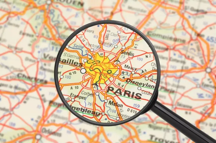 destination - paris (with magnifying glass) tourist conceptual image