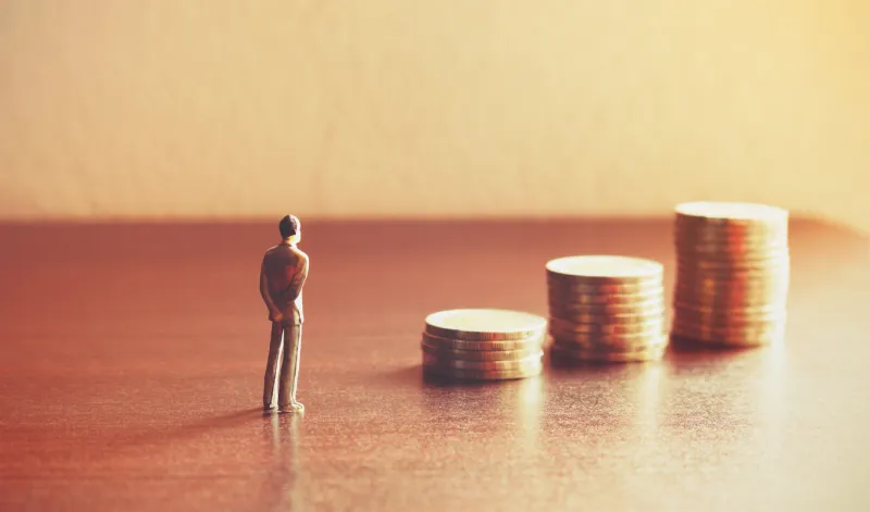 miniature people looking future with stack coin about financial and money savings concept