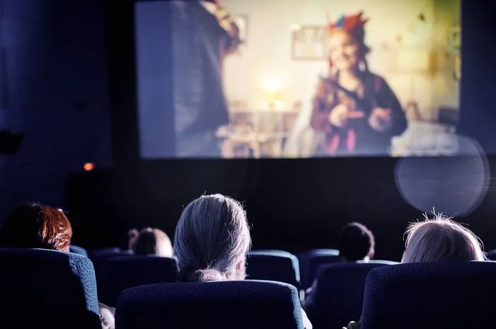 rear view shot of unrecognizable people spending spare time watching family movie on big screen at cinema