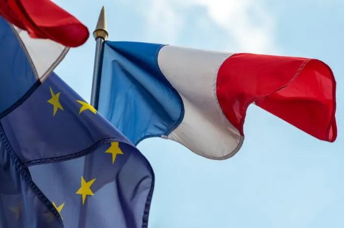 french and european union flags fluttering together in the wind close-up shot