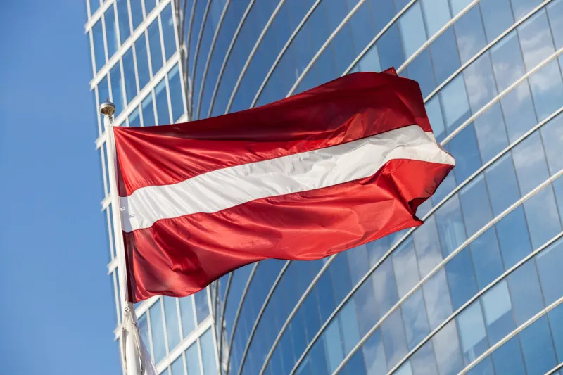 latvian flag against skyscraper in riga