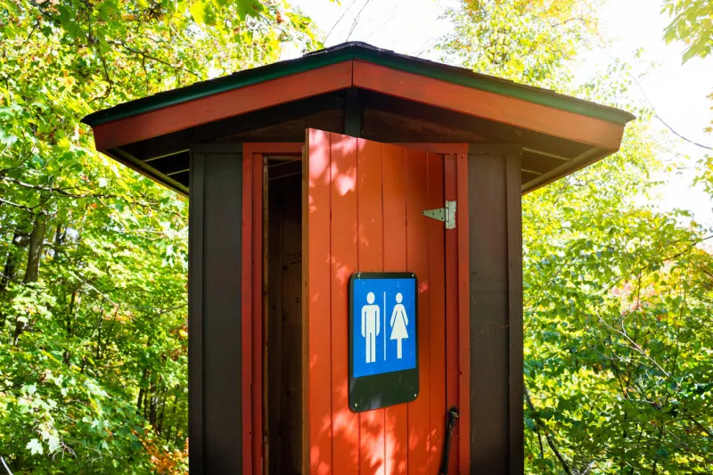 gorgeous red and brown public toilet in the middle of the woods, gatineau park ,quebec, canada
