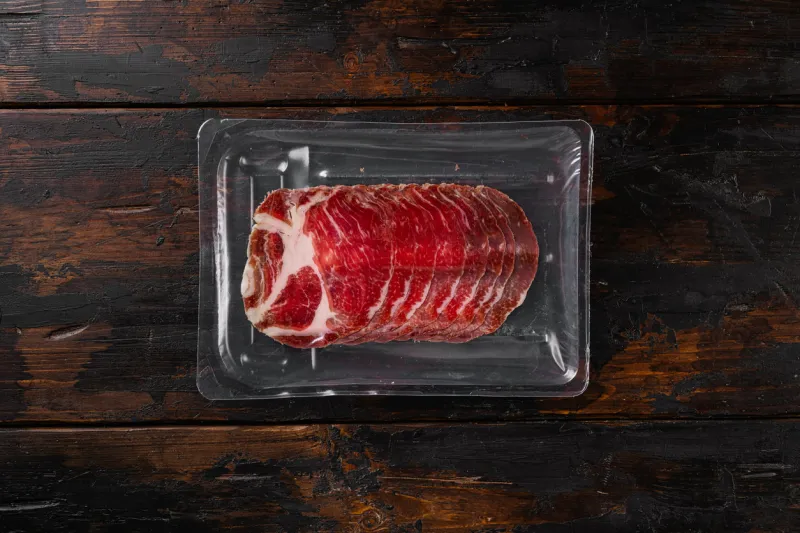 italian meat cold cuts pack set, on old dark wooden table background, top view flat lay, with copy space for text