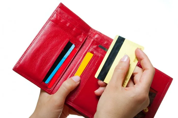 hands with a purse and card