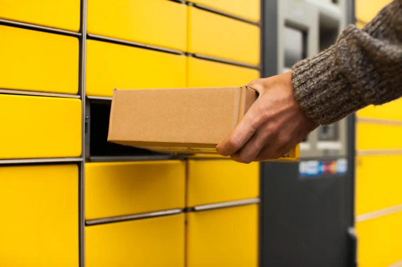 yellow self-service post terminal machine man recieve a parcel