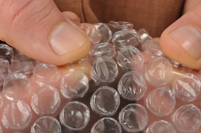 macro of hands with bubble wrap