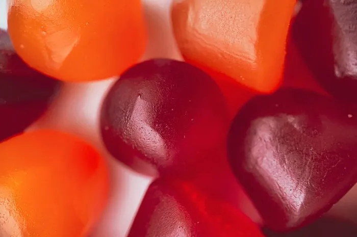 close-up texture of red, orange and purple multivitamin gummies healthy lifestyle concept