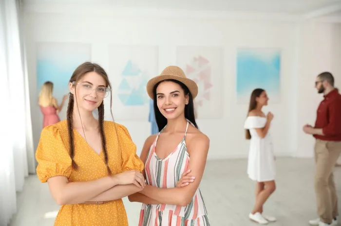 young women at exhibition in art gallery